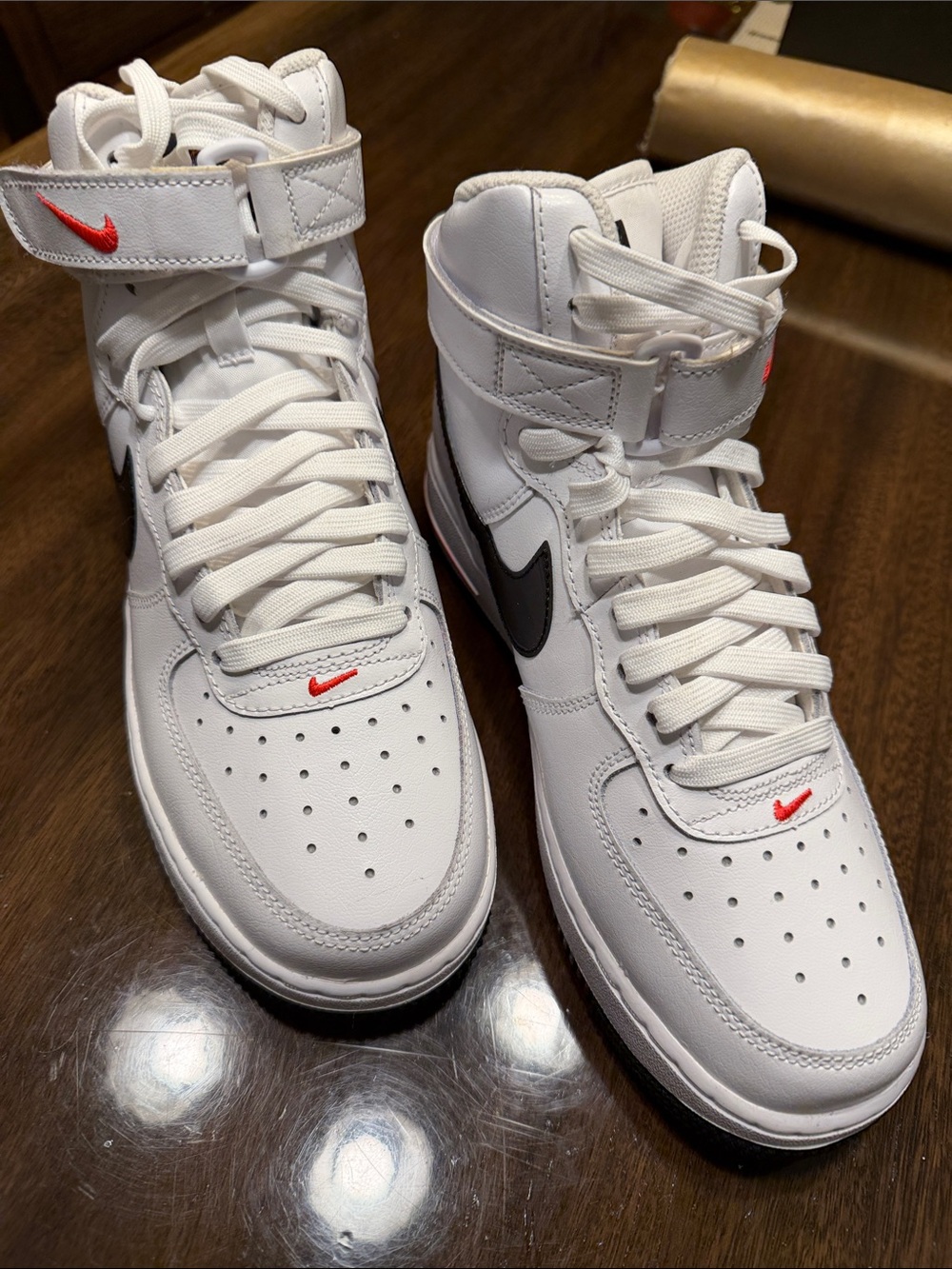 Nike White High-Top Sneakers with Black Swoosh and Red Accents
